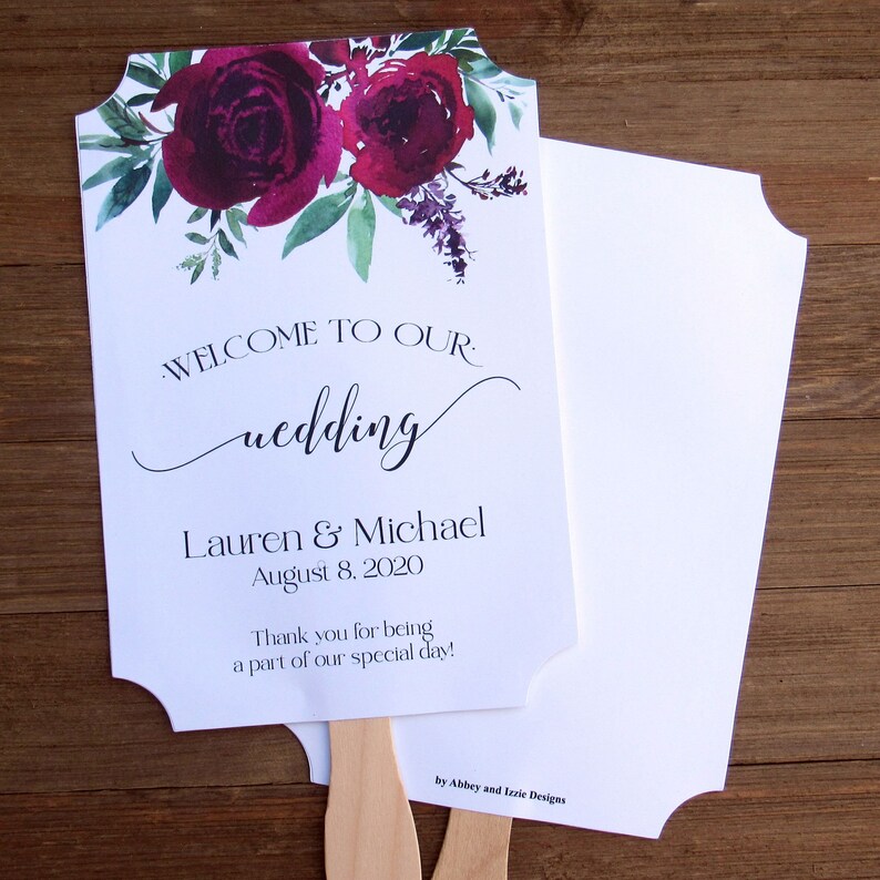 May include: White wedding fan with a burgundy floral design. The text reads "Welcome to our wedding, Lauren & Michael, August 8, 2020. Thank you for being a part of our special day!"  by Abbey and Izzie Designs.