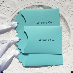 Wedding favors for Tiffany, personalized with the last name & Co. of the lucky couple.  Lottery ticket wedding favors are fun and unique, slide a lotto ticket in and see who wins big!  Aqua blue favors with a white ribbon which comes attached.
