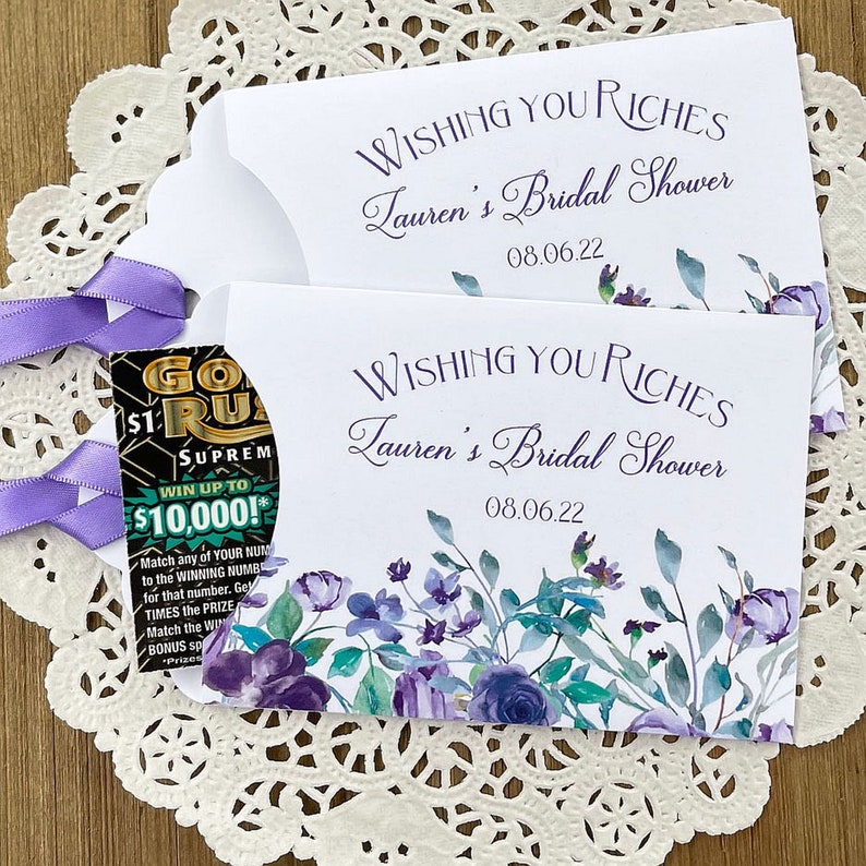Wishing you riches bridal shower lotto ticket favors.  Favor envelopes are adorned with lavender flowers and ribbon which comes attached, personalized for the bride to be, these make fun bridal shower favors.