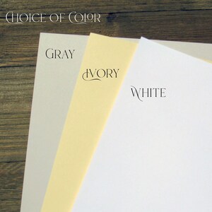 May include: Three paper samples in grey, ivory, and white. The text "Choice of Color" is at the top of the image. The text "Grey", "Ivory", and "White" are written below each paper sample.