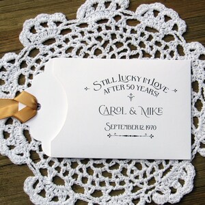 Our 50th wedding anniversary favors are personalized for the happy couple.  Printed on white cardstock with gold ribbon attached these will be a fun favor to give to guests.  Slide a lotto ticket in the open end and see who wins.
