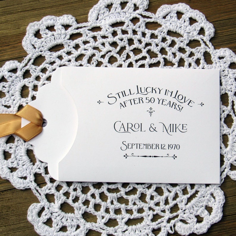 Our 50th wedding anniversary favors are personalized for the happy couple.  Printed on white cardstock with gold ribbon attached these will be a fun favor to give to guests.  Slide a lotto ticket in the open end and see who wins.