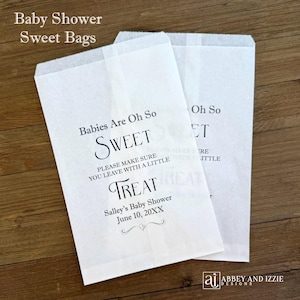 May include: Two white paper treat bags with text that reads "Babies Are Oh So Sweet" and "Treat". The bags are for a baby shower and include the name "Salley" and the date "June 10, 20XX".