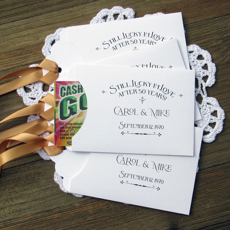 Our 50th wedding anniversary favors are personalized for the happy couple.  Printed on white cardstock with gold ribbon attached these will be a fun favor to give to guests.  Slide a lotto ticket in the open end and see who wins.