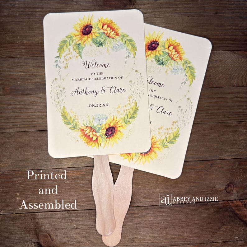 Sunflower wedding fans , personalized for the bride and groom and adorned with a ring of sunflowers.  Fans are printed on ivory or white cardstock, two sided so handle is hidden between.  Wedding fans ship fully assembled and ready for your big day.