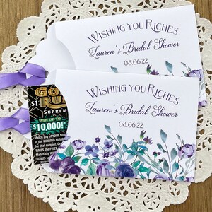 Wishing you riches bridal shower lotto ticket favors.  Favor envelopes are adorned with lavender flowers and ribbon which comes attached, personalized for the bride to be, these make fun bridal shower favors.