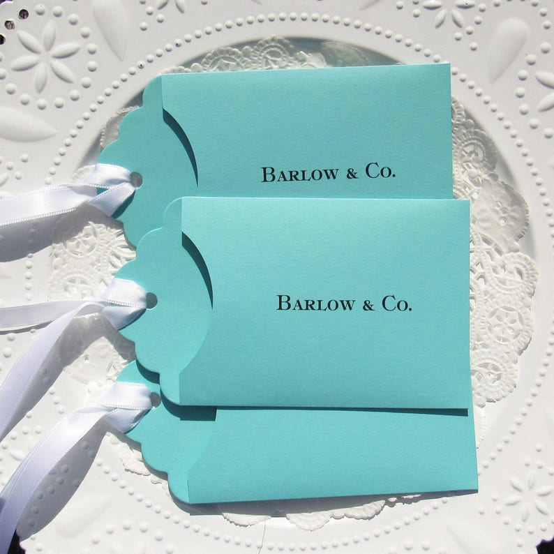 Wedding favors for Tiffany, personalized with the last name & Co. of the lucky couple.  Lottery ticket wedding favors are fun and unique, slide a lotto ticket in and see who wins big!  Aqua blue favors with a white ribbon which comes attached.