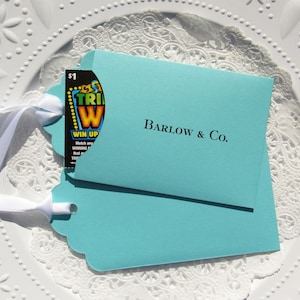 Wedding favors for Tiffany, personalized with the last name & Co. of the lucky couple.  Lottery ticket wedding favors are fun and unique, slide a lotto ticket in and see who wins big!  Aqua blue favors with a white ribbon which comes attached.