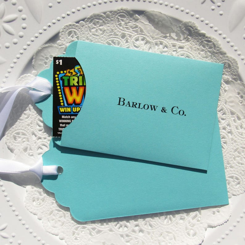 Wedding favors for Tiffany, personalized with the last name & Co. of the lucky couple.  Lottery ticket wedding favors are fun and unique, slide a lotto ticket in and see who wins big!  Aqua blue favors with a white ribbon which comes attached.