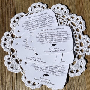 Our sweet graduation favor tags printed with a saying letting your guests know how much they mean to you.  Printed on white card stock with large class year in the back ground.  They are personalized with the graduates name and school.