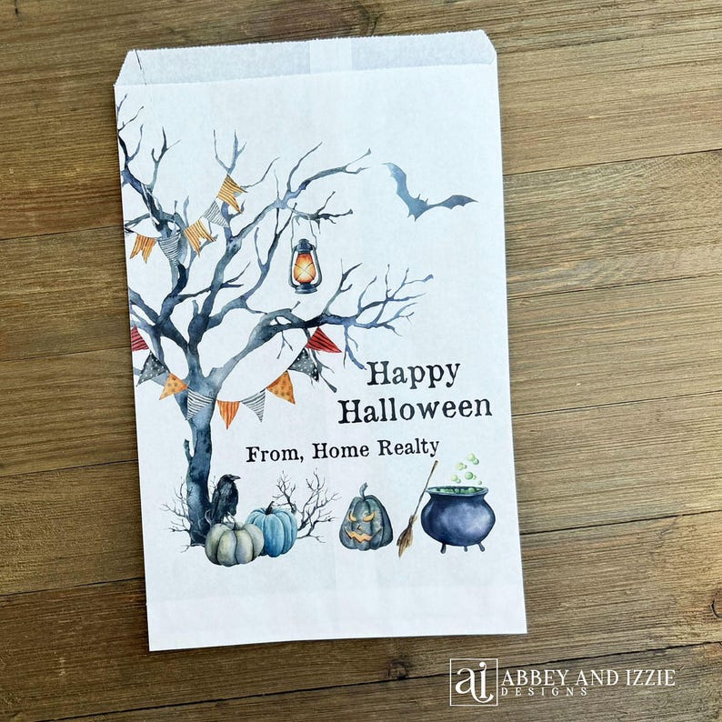 May include: White paper Halloween treat bag with a watercolor design. Features a spooky tree, pumpkins, a cauldron, and a bat. Text reads "Happy Halloween From, Home Realty."