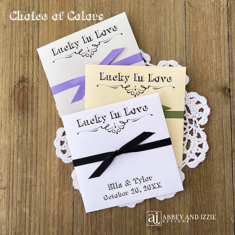 Lucky in love lottery ticket envelopes for wedding favors.  Slide a lotto ticket in these personalized envelopes for a fun favor.  Your choice of envelope and ribbon color, ribbon included and comes attached.  Easy and fun wedding guest favors.