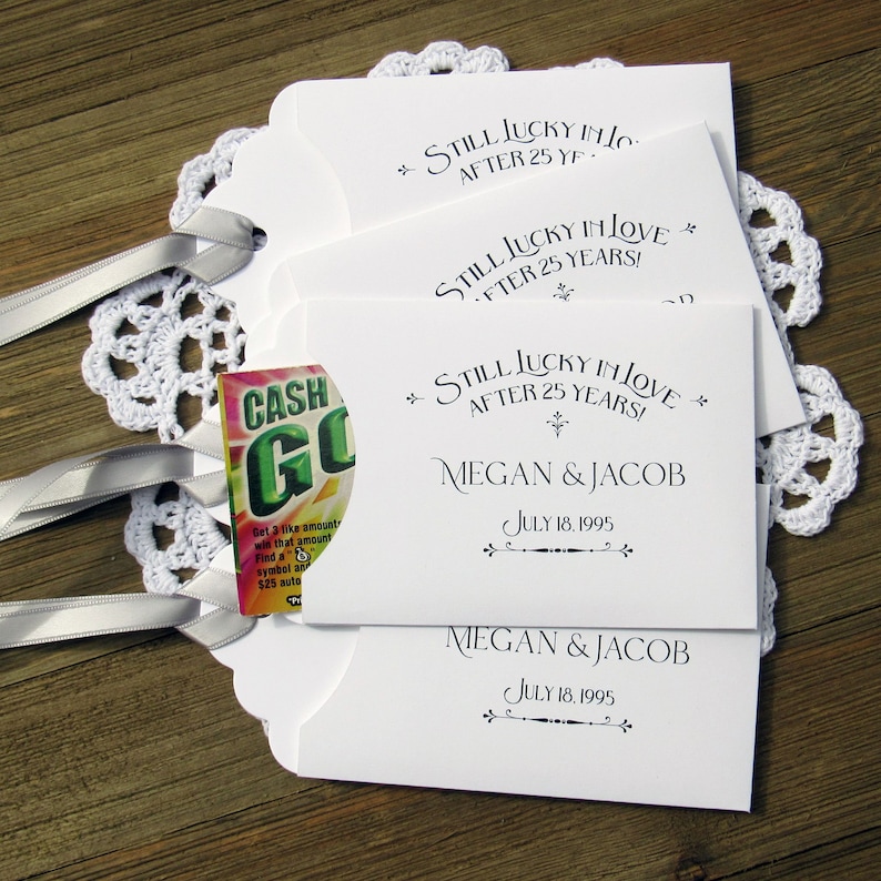 Personalized silver wedding anniversary favors, printed with 'still lucky in love after 25 years' with the couples name and wedding date.  Slide a lotto ticket in to see who is the lucky winner.
