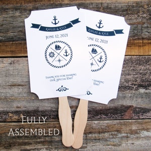 Nautical wedding fans, printed on white card stock with navy text and details.  Fans are personalized for the bride and groom with names and date.  Fans are shipped fully assembled, two sided with hand hidden between.