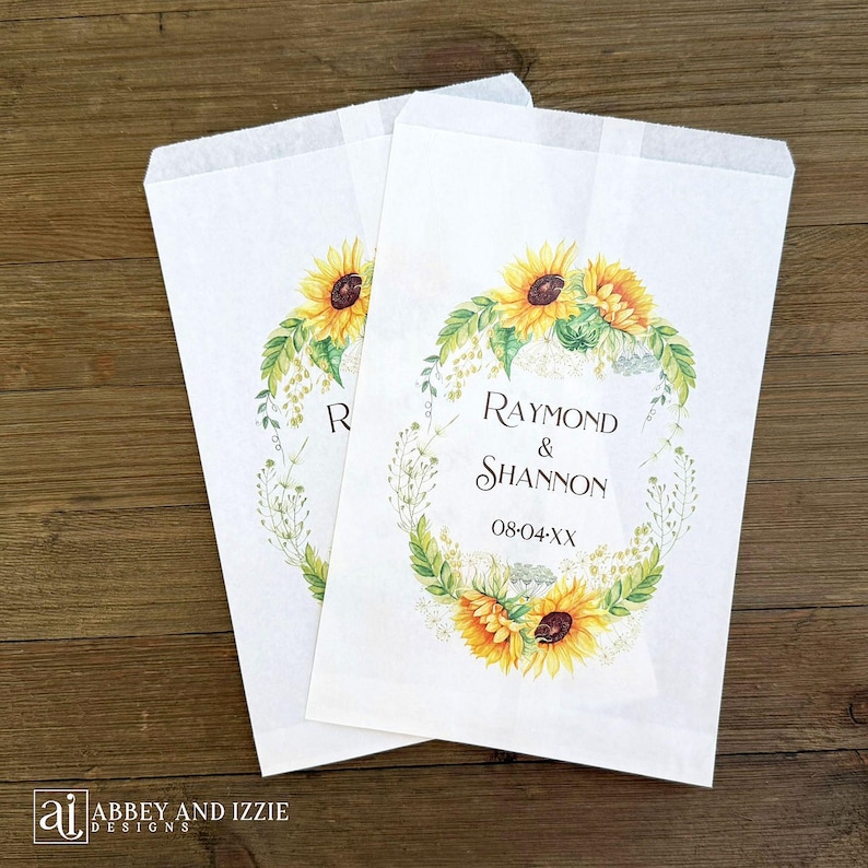 Sunflower wedding favor bags that are personalized for the bride and groom.  Adorned with a circle of sunflowers.  Perfect for cookies or a candy buffet.