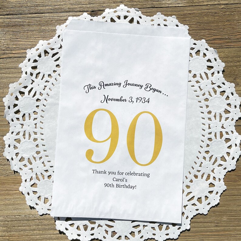 Personalized 90th birthday favor bags, printed on white bags, your choice of number color.  Bags are personalized with large birthday number, name of guest of honor along with birth date.  Adult favor bags perfect for many treats to thank your guests
