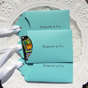 Wedding favors for Tiffany, personalized with the last name & Co. of the lucky couple.  Lottery ticket wedding favors are fun and unique, slide a lotto ticket in and see who wins big!  Aqua blue favors with a white ribbon which comes attached.
