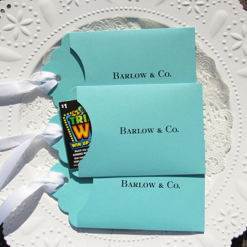 Wedding favors for Tiffany, personalized with the last name & Co. of the lucky couple.  Lottery ticket wedding favors are fun and unique, slide a lotto ticket in and see who wins big!  Aqua blue favors with a white ribbon which comes attached.
