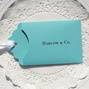 Wedding favors for Tiffany, personalized with the last name & Co. of the lucky couple.  Lottery ticket wedding favors are fun and unique, slide a lotto ticket in and see who wins big!  Aqua blue favors with a white ribbon which comes attached.