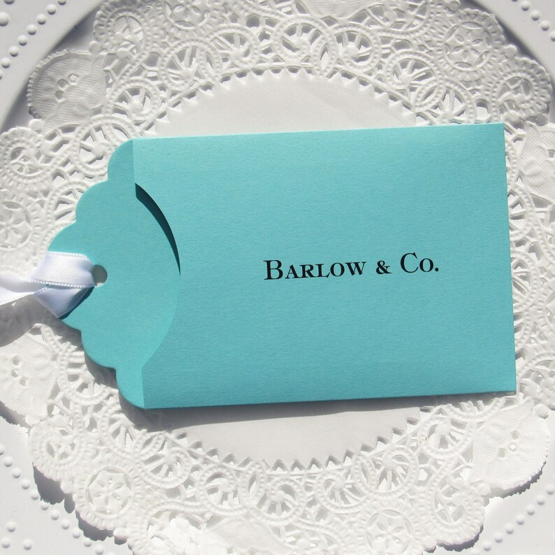 Wedding favors for Tiffany, personalized with the last name & Co. of the lucky couple.  Lottery ticket wedding favors are fun and unique, slide a lotto ticket in and see who wins big!  Aqua blue favors with a white ribbon which comes attached.