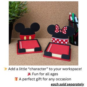 May include: Two square memo pad holders featuring character-themed backings. One holder has a black mouse-ear silhouette with red shorts and yellow buttons. The other has a black mouse-ear silhouette with a red and white polka dot bow and skirt.