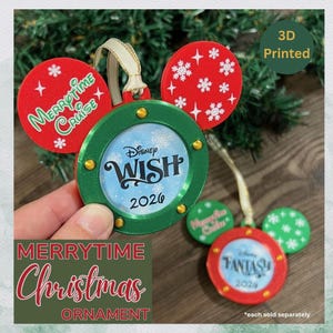 May include: A 3D printed Christmas ornament shaped like Mickey Mouse ears with a green porthole frame. The center features the text Disney WISH 2026. The red ears have white snowflake patterns and the text Merrytime Cruise.
