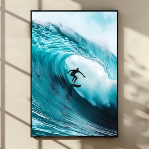 May include: Framed print of a surfer silhouetted against a large, turquoise wave. The artwork captures the power and beauty of the ocean. The wave is breaking, creating a dramatic and dynamic scene.