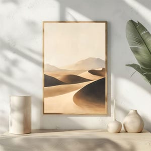 May include: A framed print of a desert landscape with rolling sand dunes in shades of brown and beige. The dunes are illuminated by a soft, warm light, creating a sense of tranquility and serenity.