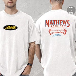 May include: White t-shirt featuring the Mathews logo on the front and back. The front has a small oval logo with the word "Mathews" in gold lettering. The back displays "MATHEWS ARCHERY" in red and blue, with a bow and arrow graphic.