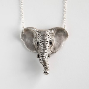 sterling silver elephant head pendant with black spinel eyes on white background