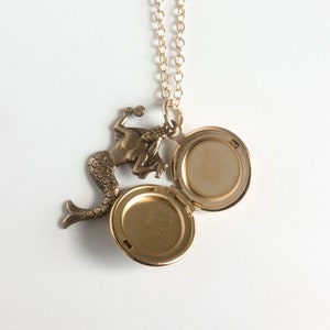 open initial locket with mermaid charm, on white background