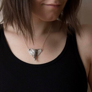 sterling silver elephant head pendant on model wearing black shirt