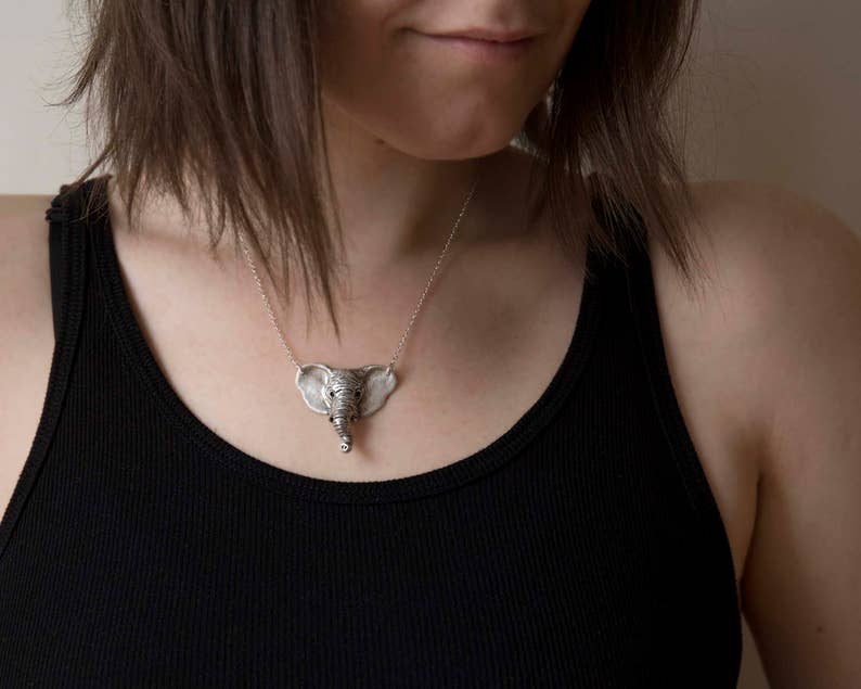 sterling silver elephant head pendant on model wearing black shirt