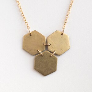 three brass hexagons pendant on white background