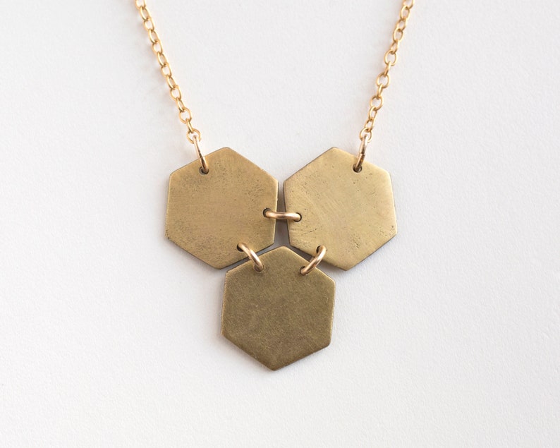 three brass hexagons pendant on white background