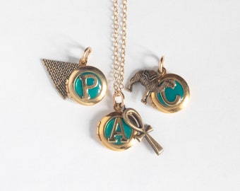 Personalized Tiny Locket with Initial, with an Egyptian-themed theme brass charm. Select ankh, camel, or pyramid