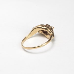 14k gold double giraffe head ring, with opal cabochon laying on white background
