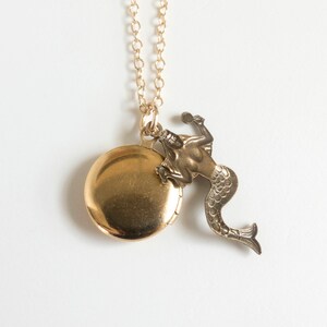 back of initial locket with mermaid charm, on white background