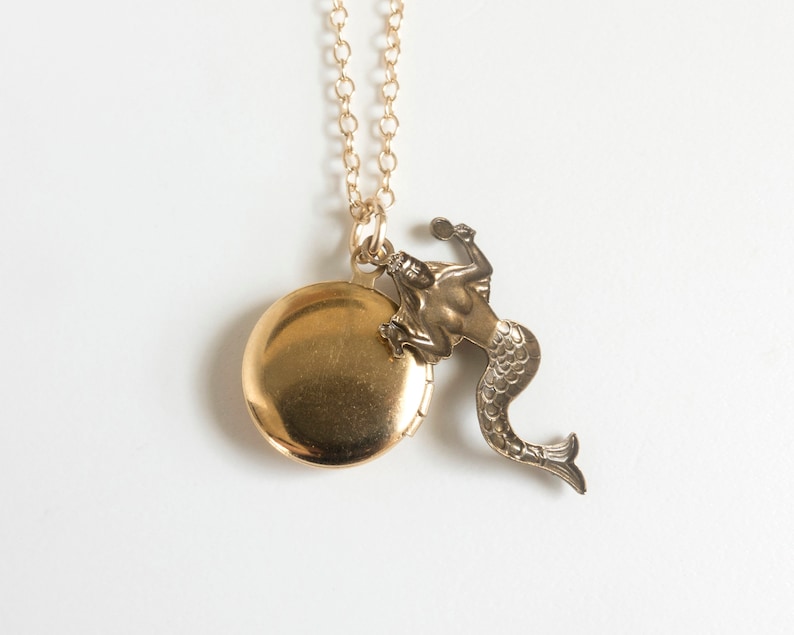back of initial locket with mermaid charm, on white background