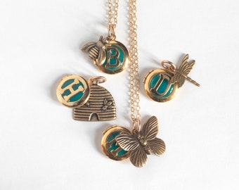 Personalized Initial Tiny Locket, with an insect theme brass charm. Select bee, hive, butterfly, or dragonfly