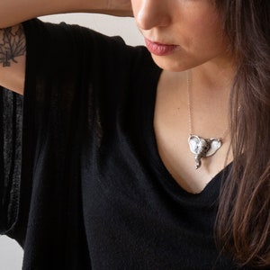 sterling silver elephant head necklace on model wearing black shirt