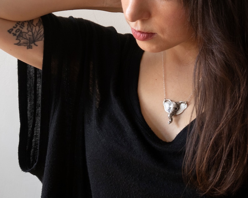 sterling silver elephant head necklace on model wearing black shirt