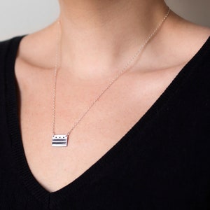 sterling silver washington DC flag necklace, on model's neck