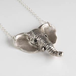 sterling silver elephant head pendant with black spinel eyes on white background