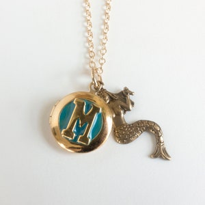 initial locket with mermaid charm, on white background