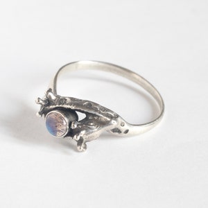 two giraffes ring in silver with labradorite, laying at an angle on a white background
