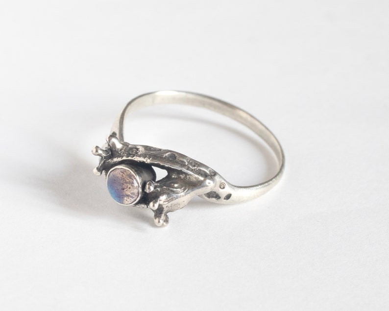 two giraffes ring in silver with labradorite, laying at an angle on a white background