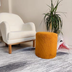 Orange ottoman,Plush stool,Wooden frame ottoman,Comfortable seating,Modern decor,Home decoration,Soft sponge ottoman,Minimalist furniture
