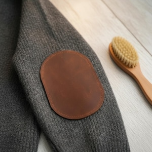 May include: A distressed wooden sign with the words "Welcome to our home" in white. The sign has a rustic finish, ideal for adding a welcoming touch to a home's entrance.