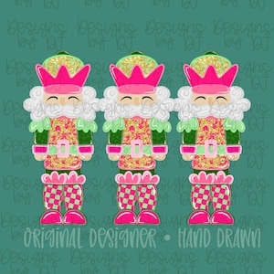 May include: Three colourful nutcracker figures with pink, green, and gold details. Each has a pink crown, a white beard, and a patterned torso. The legs are checkered pink and green. The words "Original Designer - Hand Drawn" are at the bottom.